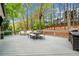 Large deck with a dining table, seating area, and grill, overlooking a private backyard at 3969 Bear Ridge Nw Pl, Kennesaw, GA 30144