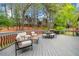 Expansive deck with multiple seating areas, a dining table, and a grill, ideal for outdoor living at 3969 Bear Ridge Nw Pl, Kennesaw, GA 30144