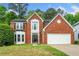 Charming two-story red brick home with a well-manicured lawn, attached two-car garage, and mature trees at 3969 Bear Ridge Nw Pl, Kennesaw, GA 30144