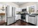 Well-lit kitchen featuring stainless steel appliances and white cabinetry at 3969 Bear Ridge Nw Pl, Kennesaw, GA 30144