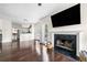 Open-concept living room with a fireplace and views into the kitchen and back deck at 3969 Bear Ridge Nw Pl, Kennesaw, GA 30144