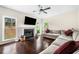 Bright living room with fireplace, hardwood floors, and large windows overlooking the backyard at 3969 Bear Ridge Nw Pl, Kennesaw, GA 30144