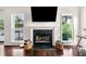 Bright living room with a fireplace, large windows, and hardwood floors at 3969 Bear Ridge Nw Pl, Kennesaw, GA 30144