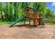 A wooden playset is on display with a green slide and ladder, offering outdoor entertainment for  at 3969 Bear Ridge Nw Pl, Kennesaw, GA 30144