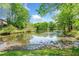 Scenic pond in the community with lush green trees reflecting on the water's surface, creating a peaceful setting at 3969 Bear Ridge Nw Pl, Kennesaw, GA 30144