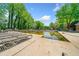 Community pool with lounge chairs surrounded by mature trees and a serene atmosphere at 3969 Bear Ridge Nw Pl, Kennesaw, GA 30144