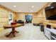Finished basement features wood paneled walls, recessed lighting, and a recreational game room at 6765 Creek View Ln, Cumming, GA 30041