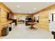 Finished basement with wood paneled walls, recessed lighting, and arcade games at 6765 Creek View Ln, Cumming, GA 30041