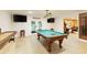 Finished basement with a pool table, a shuffleboard table, and walkout doors at 6765 Creek View Ln, Cumming, GA 30041