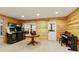 Finished basement with arcade games, wood paneled walls, recessed lights, and a piano at 6765 Creek View Ln, Cumming, GA 30041