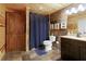 Rustic bathroom features stone flooring, wood accents, and a stylish vanity with ample storage at 6765 Creek View Ln, Cumming, GA 30041