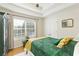 Comfortable bedroom with a queen-size bed, neutral walls, and a large window for ample natural light at 6765 Creek View Ln, Cumming, GA 30041