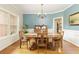 Traditional dining room featuring a wood table, chandelier, and large window for natural light at 6765 Creek View Ln, Cumming, GA 30041