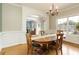 Elegant dining room with wood floors, a chandelier, and natural light from large windows at 6765 Creek View Ln, Cumming, GA 30041