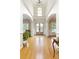 Bright foyer with high ceilings, arched entryways, and a glass-paneled front door at 6765 Creek View Ln, Cumming, GA 30041