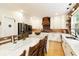 Bright kitchen featuring granite countertops, white cabinetry, stainless steel appliances, and a brick backsplash at 6765 Creek View Ln, Cumming, GA 30041