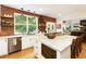 Beautiful kitchen with a large island, stainless appliances, hardwood floors, brick accent wall, and white cabinetry at 6765 Creek View Ln, Cumming, GA 30041