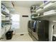 The laundry room features modern appliances, ample shelving, and a tile floor, for organized convenience at 6765 Creek View Ln, Cumming, GA 30041