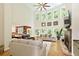Light-filled living room with a fireplace, hardwood floors, and views into the dining area at 6765 Creek View Ln, Cumming, GA 30041