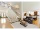 Stunning living room with hardwood floors and a staircase to the second floor at 6765 Creek View Ln, Cumming, GA 30041