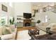 Bright living room boasts hardwood floors, a fireplace, and modern finishes at 6765 Creek View Ln, Cumming, GA 30041