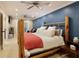 Main bedroom featuring a rustic bed frame, blue wall and bright lighting at 6765 Creek View Ln, Cumming, GA 30041