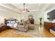 Spacious main bedroom suite boasts tray ceilings, hardwood floors and sitting area at 6765 Creek View Ln, Cumming, GA 30041