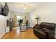 Home office with hardwood floors, neutral paint, and a leather chair at 6765 Creek View Ln, Cumming, GA 30041