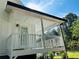 Clean, covered back porch with white railing, siding, and trim, offering a bright outdoor space at 102 Collins Way, Douglasville, GA 30134