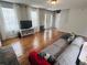 Bright living room showcasing hardwood floors, fireplace, and a comfortable sofa at 102 Collins Way, Douglasville, GA 30134