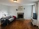Comfortable living room featuring a stone fireplace and hardwood floors at 102 Collins Way, Douglasville, GA 30134