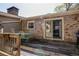 Back deck with a dining table and outdoor seating adjacent to brick home at 1336 Shirley Dr, Sugar Hill, GA 30518
