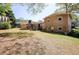 Large backyard with a well-maintained lawn and a view of the back of the house at 1336 Shirley Dr, Sugar Hill, GA 30518