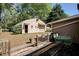 Exterior view of the backyard with a large deck and Quonset hut at 1336 Shirley Dr, Sugar Hill, GA 30518