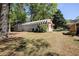 Large backyard featuring green lawn, shed and trees, perfect for outdoor activities at 1336 Shirley Dr, Sugar Hill, GA 30518