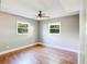 Bright bedroom with hardwood floors and natural light from two windows at 1336 Shirley Dr, Sugar Hill, GA 30518