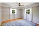 Bedroom with hardwood floors, ceiling fan, neutral walls and a large area rug at 1336 Shirley Dr, Sugar Hill, GA 30518