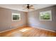 Bedroom with hardwood floors, neutral walls, and natural light from windows at 1336 Shirley Dr, Sugar Hill, GA 30518