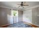 Bedroom with hardwood floors, ceiling fan, and double-door closet at 1336 Shirley Dr, Sugar Hill, GA 30518