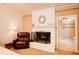 Bedroom fireplace with whitewashed brick, a decorative mantel, and an adjacent bathroom at 1336 Shirley Dr, Sugar Hill, GA 30518