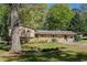 Charming single-story home featuring a well-manicured front yard with mature trees at 1336 Shirley Dr, Sugar Hill, GA 30518