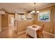 Eat-in kitchen boasts white cabinets, tile flooring, and a cozy breakfast nook at 1336 Shirley Dr, Sugar Hill, GA 30518