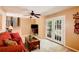 Bright living room with French doors, carpet flooring, a ceiling fan, and access to stairs at 1336 Shirley Dr, Sugar Hill, GA 30518