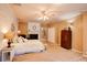 Spacious bedroom features a whitewashed brick wall, fireplace, ceiling fan, and ample natural light at 1336 Shirley Dr, Sugar Hill, GA 30518