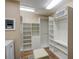 Spacious walk-in closet with custom shelving, drawers, and ottoman for optimal storage and organization at 1336 Shirley Dr, Sugar Hill, GA 30518