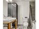 Modern bathroom with a stylish sink, a dark cabinet, and eye-catching hexagonal tile flooring at 1878 Suwanee Roberts Ct, Lawrenceville, GA 30043