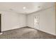 A spacious bedroom with neutral carpet and a door leading to the outside at 1878 Suwanee Roberts Ct, Lawrenceville, GA 30043
