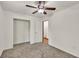 Bright bedroom showcasing neutral carpet, ceiling fan, and an entrance to the en suite bathroom at 1878 Suwanee Roberts Ct, Lawrenceville, GA 30043