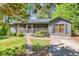 Charming home with a screened front porch, stone walkway, and beautifully landscaped front yard at 1878 Suwanee Roberts Ct, Lawrenceville, GA 30043