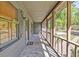 The home features a long screened porch with a stone floor, windows, and a front door at 1878 Suwanee Roberts Ct, Lawrenceville, GA 30043